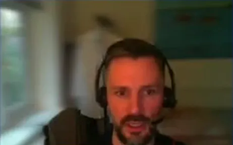 Jan Artemenko wearing a headset while presenting